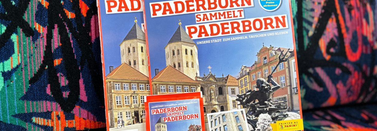 Das Panini-Sammelalbum "Paderborn sammelt Paderborn" vor einem Sitz in einem PaderSprinter-Bus